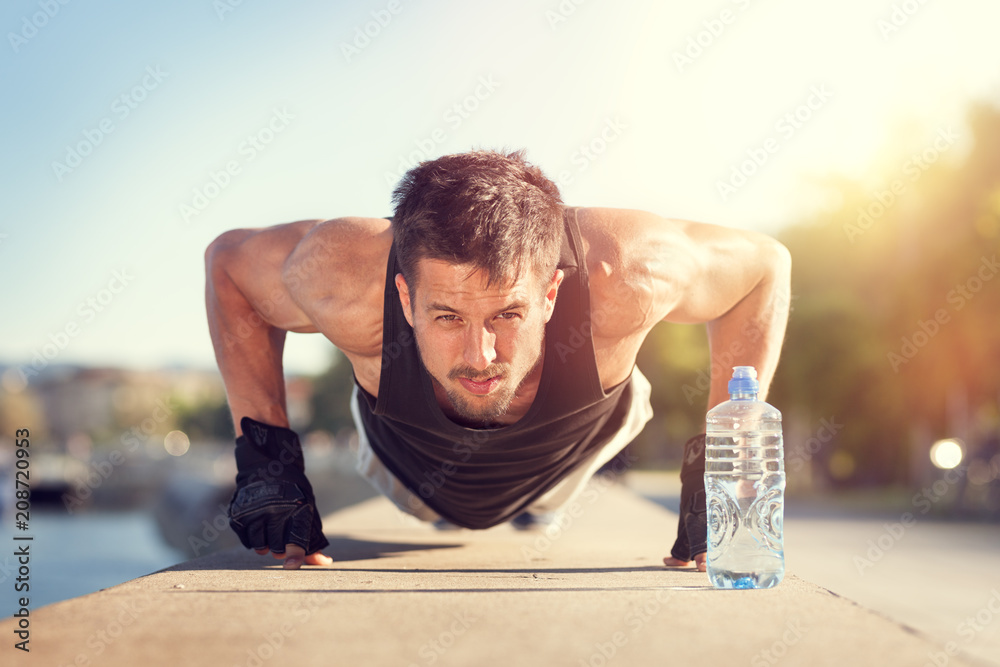 man doing push-ups on sunny summer day man doing push-ups on sunny summer day