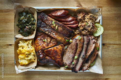 texas bbq style tray with smoked beef brisket, st louis ribs, chicken and hot links