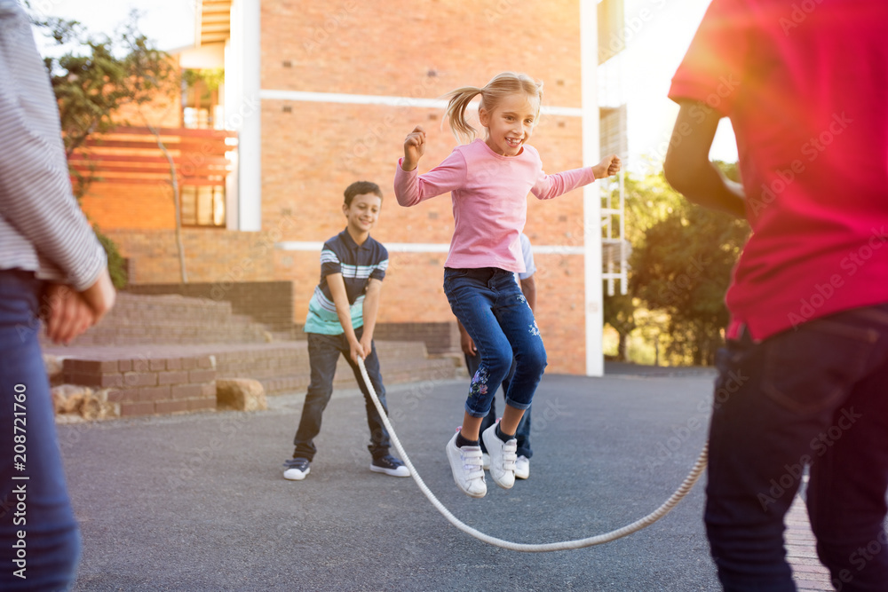 Children playing with skipping rope - obrazy, fototapety, plakaty 