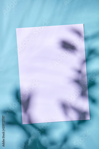 Cardboard with a pattern of shadows on a blue background with a copy space. Flat lay. photo