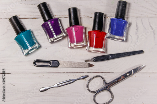 Basic set of manicure tools on white wooden background