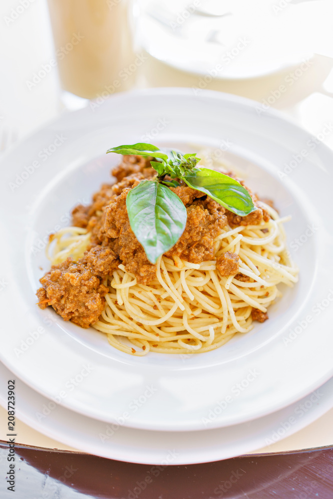 Table in cafe and enjoying the meal. Dish of spaghetti Bolognese