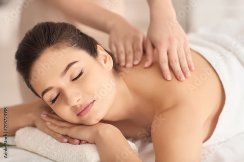 Young woman receiving massage in spa salon
