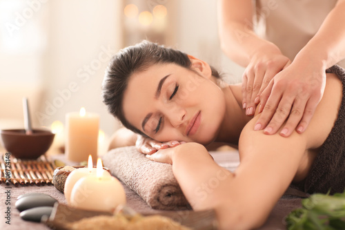 Young woman receiving massage in spa salon