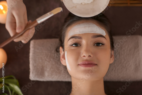 Beautician applying cosmeti...