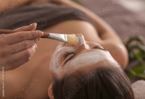 Beautician applying cosmeti...