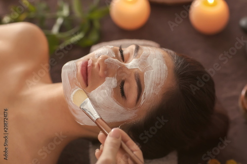 Beautician applying cosmeti...