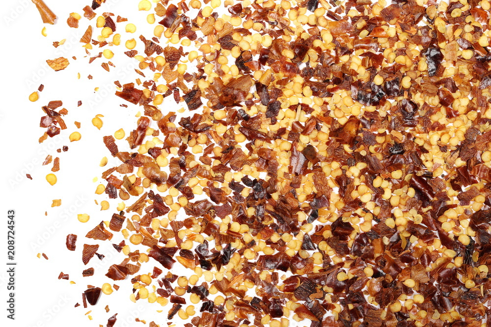 Crushed red cayenne pepper, dried chili flakes and seeds pile isolated on white background, top view Crushed red cayenne pepper, dried chili flakes and seeds pile isolated on white background, top view