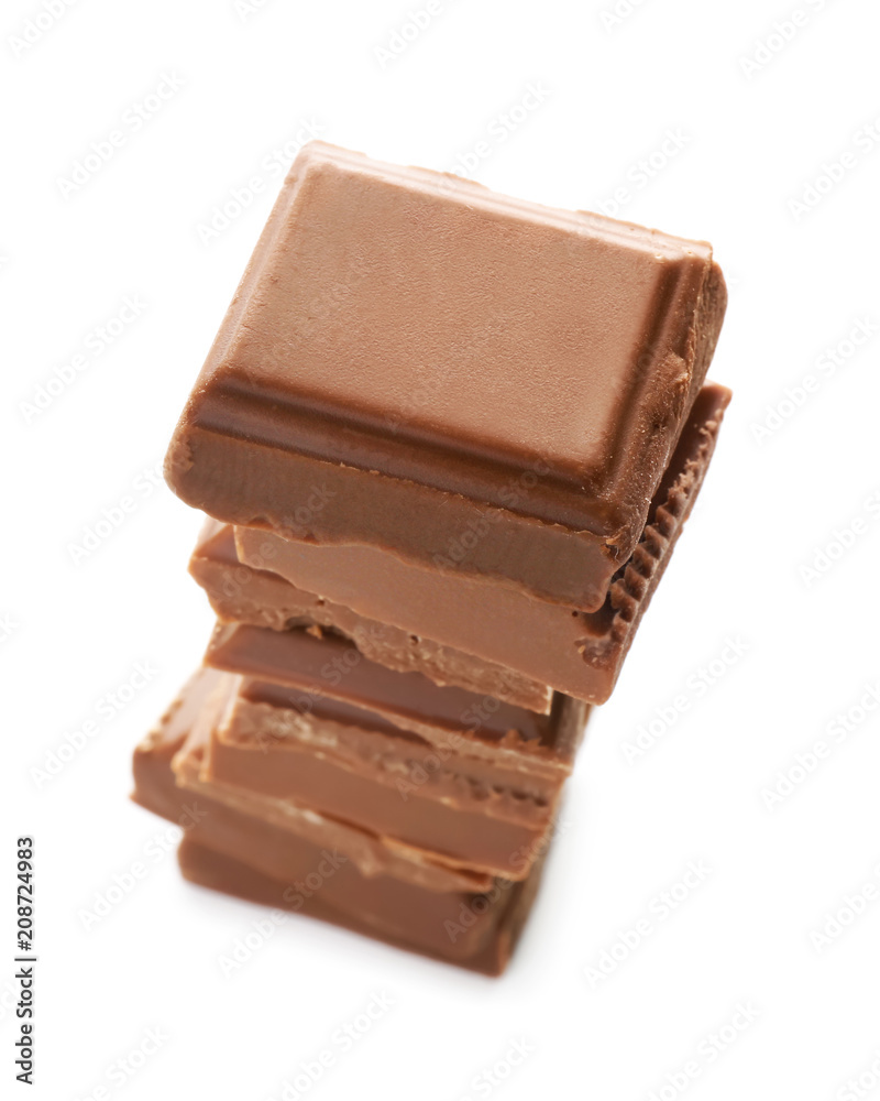 Fototapeta premium Stacked milk chocolate squares isolated on white background, sweet indulgence and dessert ingredient, this sweet treat represents indulgence and is a common ingredient in various desserts