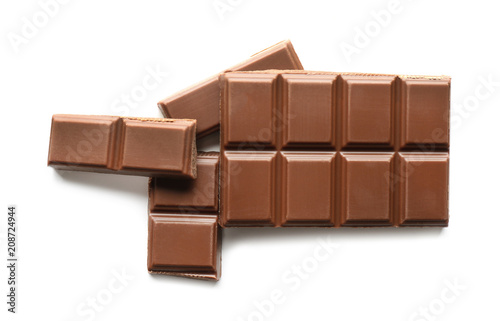 Pieces of milk chocolate on white background