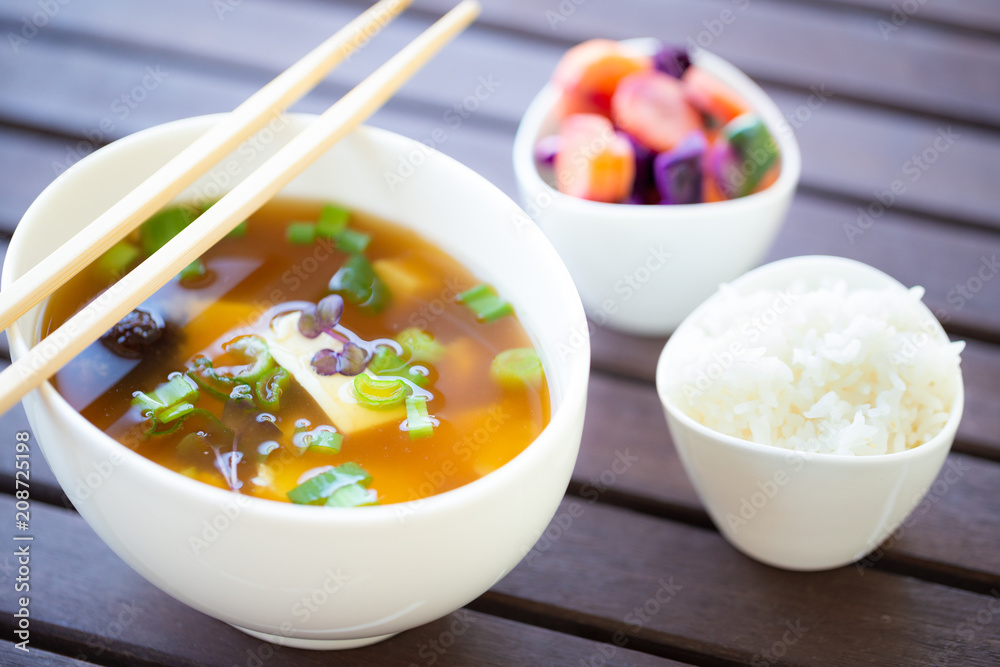 Traditional vegan miso soup with silken tofu, shiitake, dashi and scallion served with white rice and pickled vegetables Traditional vegan miso soup with silken tofu, shiitake, dashi and scallion served with white rice and pickled vegetables
