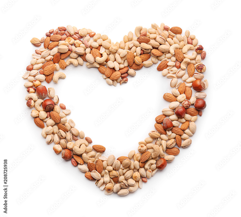 Heart made of different nuts on white background Heart made of different nuts on white background