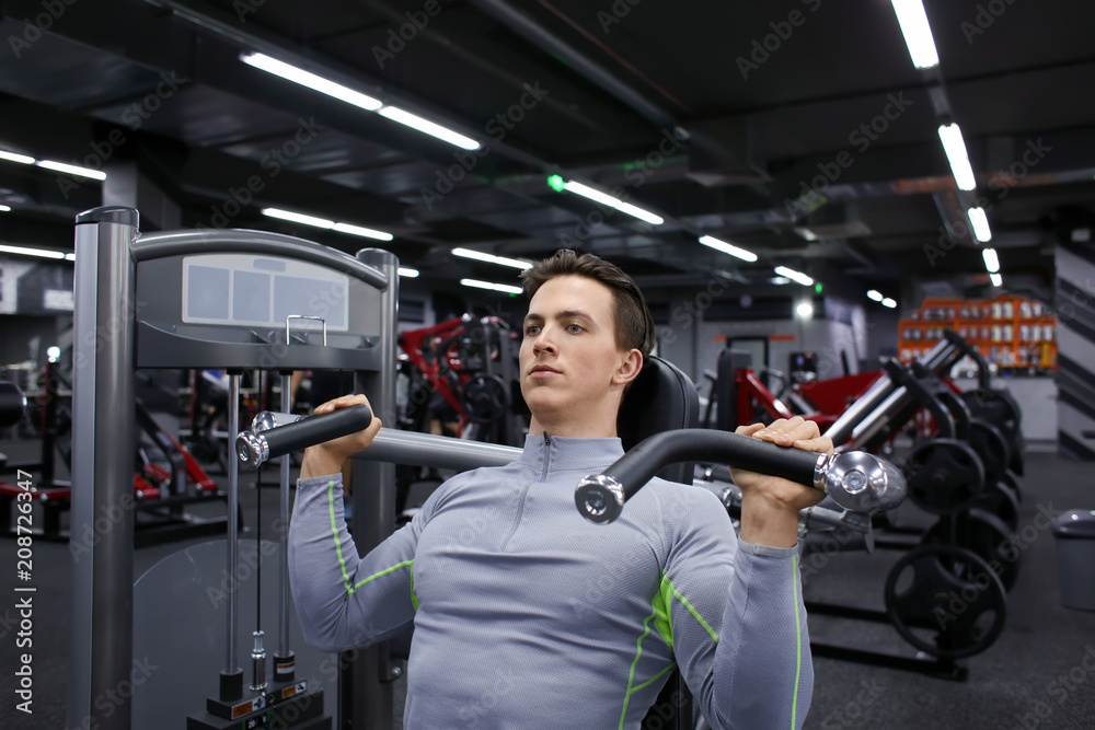 Young man training in modern gym Young man training in modern gym
