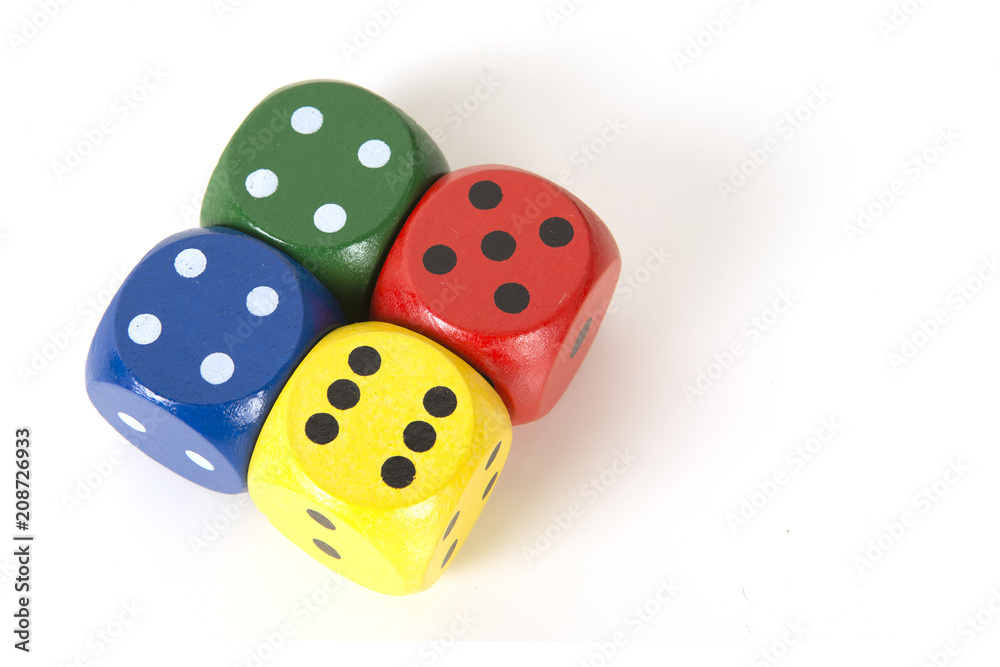 Four colorful gaming dices on a white background background seen from above lying next to each other Four colorful gaming dices on a white background background seen from above lying next to each other