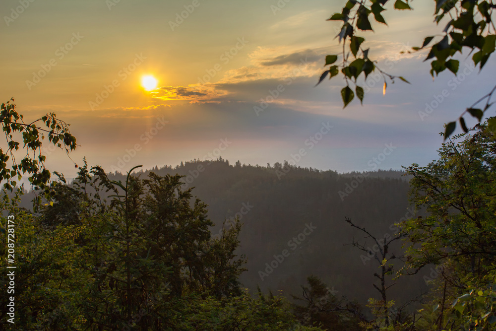 Fototapeta premium Amazing sunrise through trees, Mandelstein, Austria