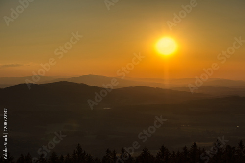 Amazing sunset on hills with sun from kravi mountains, Czech landscape