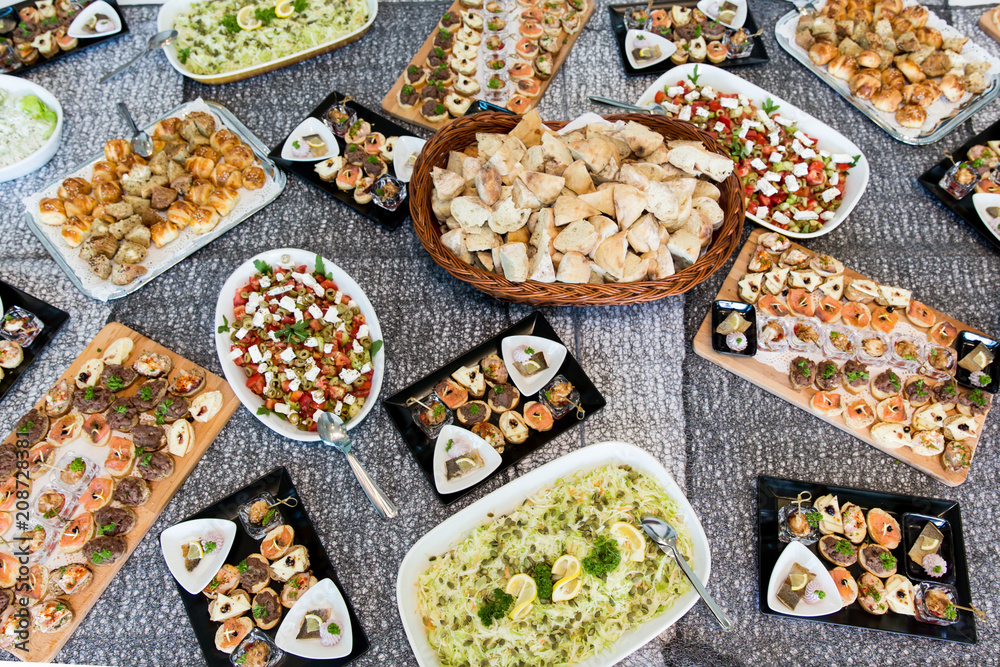 catering - table with different type of snacks preparing for party.