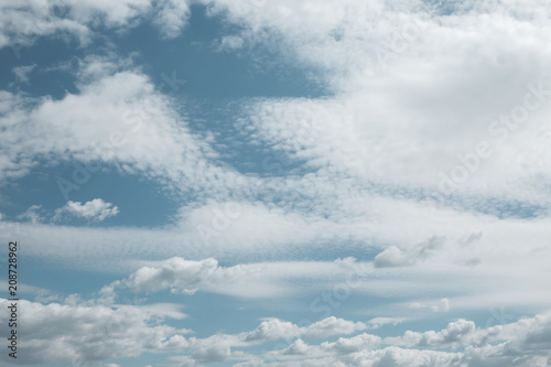 Blue sky background with tiny clouds