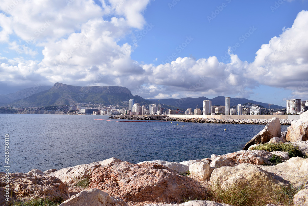 Beautiful view of the city of Calpe and the blue Spanish sky with white clouds from the promenade of the natural park of Mount Ifach