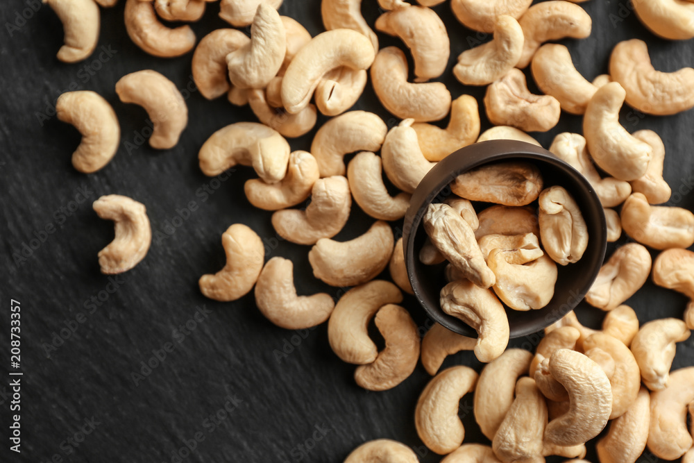 Tasty scattered cashew nuts on slate plate Tasty scattered cashew nuts on slate plate