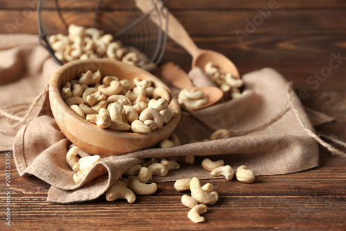 Composition with tasty cashew nuts on wooden background