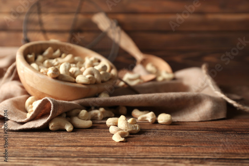 Tasty cashew nuts on wooden background