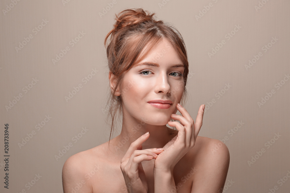 Beautiful young woman with silky skin on grey background Beautiful young woman with silky skin on grey background