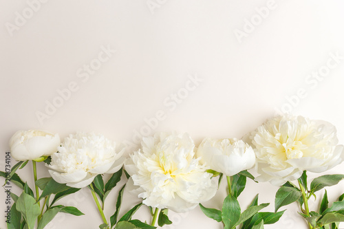 Tender spring flowers on beige background