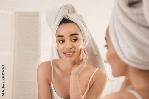 Beautiful woman near mirror in morning
