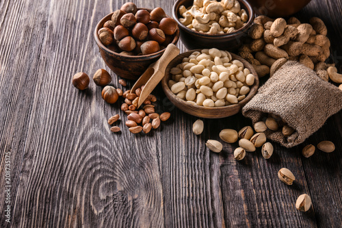 Composition with different nuts on wooden background