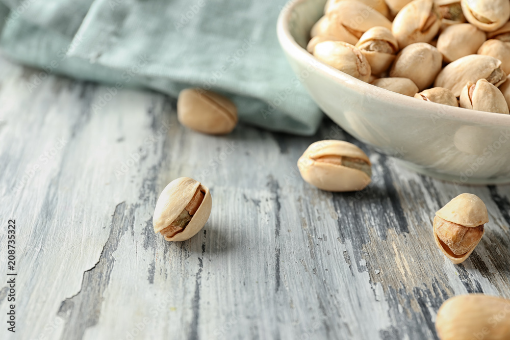 Pistachio nuts on wooden table, closeup Pistachio nuts on wooden table, closeup