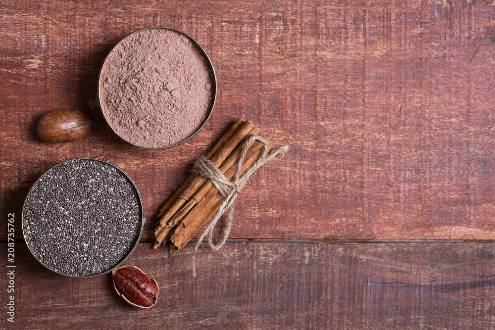 Pecan nuts, chia seeds and cocoa in a bowls on a wooden table Pecan nuts, chia seeds and cocoa in a bowls on a wooden table