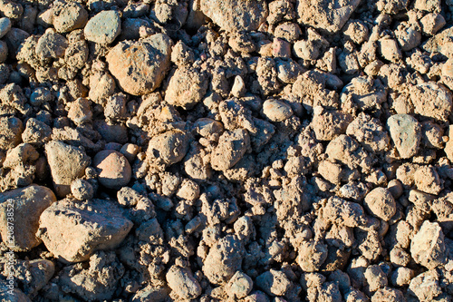 Background of pebbles in clay from above