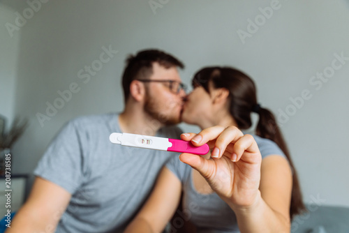 happy couple looking on pregnancy test