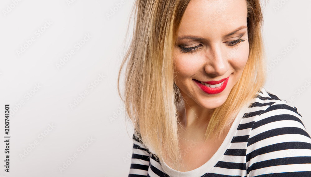 Portrait of a young beautiful woman with black and white striped top. Copy space. Portrait of a young beautiful woman with black and white striped top. Copy space.