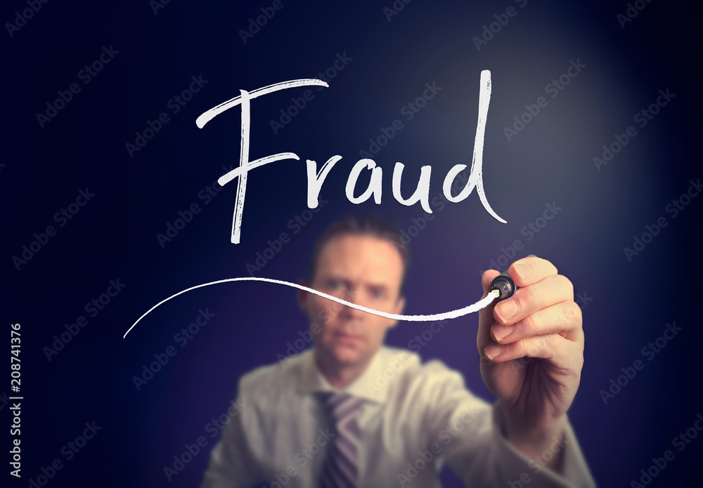 A businessman writing a Fraud concept with a white pen on a clear screen. A businessman writing a Fraud concept with a white pen on a clear screen.