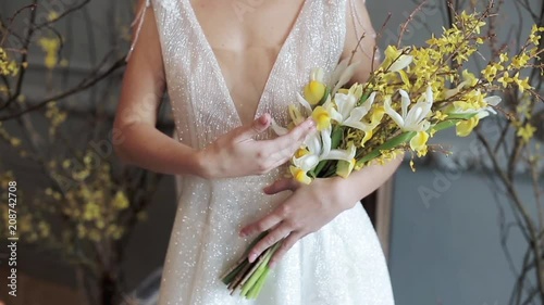 Beautiful bride is holding a wedding colorful bouquet