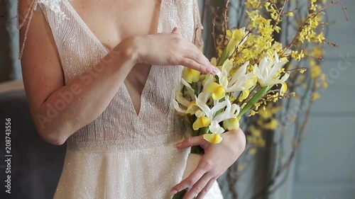 Beautiful bride is holding a wedding colorful bouquet