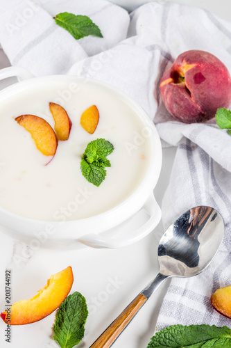 Sweet creamy peach soup  vegan summer food  white marble background copy space