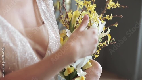 Beautiful bride is holding a wedding colorful bouquet