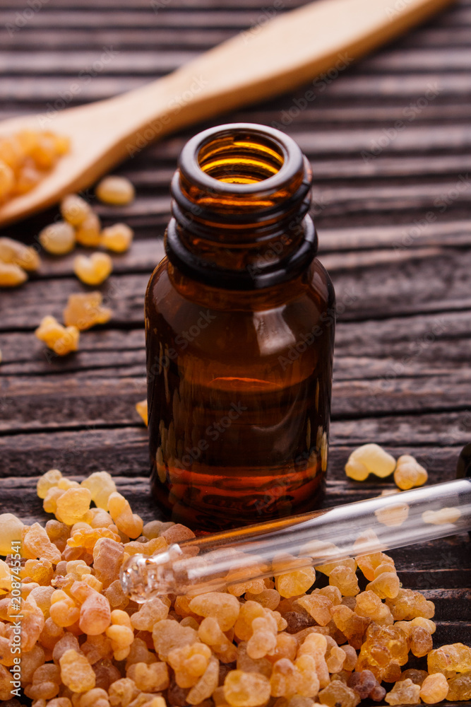 frankincense essential oil on a wooden background frankincense essential oil on a wooden background