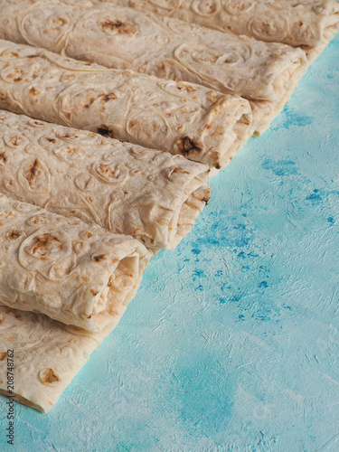 Homemade bread (lavash bread) on blue background. photo