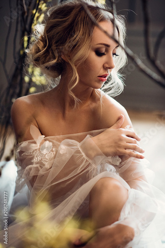 Fashionable female portrait of cute lady in white robe indoors