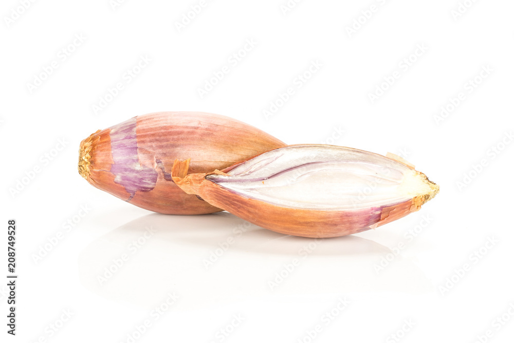 One golden shallot with one section half isolated on white background. One golden shallot with one section half isolated on white background.