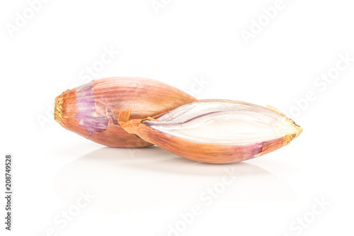 One golden shallot with one section half isolated on white background.