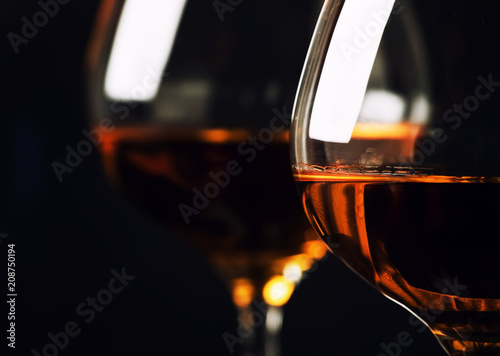 Cognac in a glass, dark background, selective focus