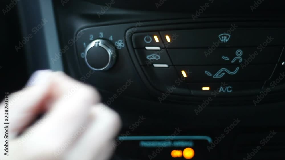 Female driver turns on conditioner and increases coolness because of hot weather Female driver turns on conditioner and increases coolness because of hot weather