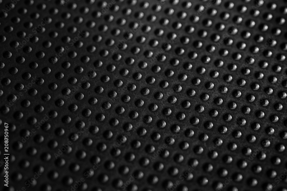 Black dotted texturised technological seamless fabric or surface closeup Black dotted texturised technological seamless fabric or surface closeup