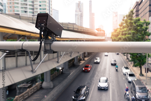 the closeup image of the security camera of cctv camera on the road which is broadcasting traffic situations. the concept of security, traffic, internet of things and transportations.