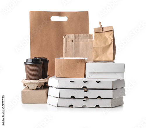 Different types of packages on white background. Food delivery service photo